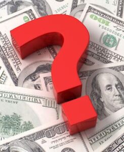 Red question mark on the background of one hundred dollar bills
